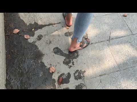 Inan stepped on the damp surface of the wet ground with her bare feet and left a lot of footprints