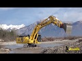 Komatsu pc360nlc11 excavator digging gravel in the water