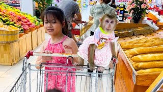 Diem hugging monkey Kaka sitting on a supermarket trolley is so cute