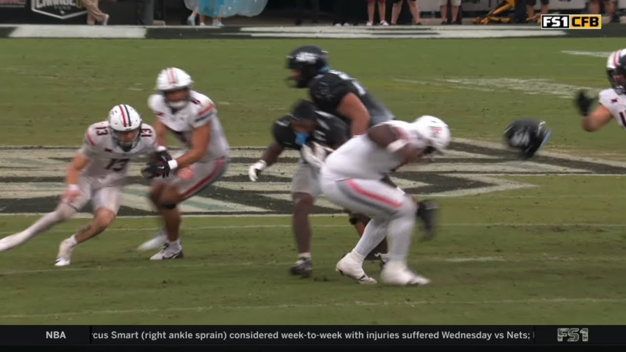 UCF RB's helmet goes flying on vicious facemask penalty