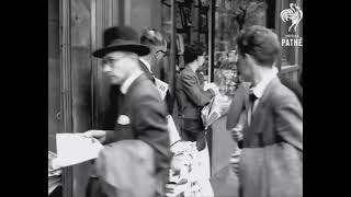 A quick stop to buy a newspaper. London, 1950s.
