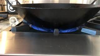 Wok on a Blue Star range.