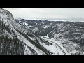 Snowy majesty aerial ballet over snowcloaked mountain peaks in 4k 