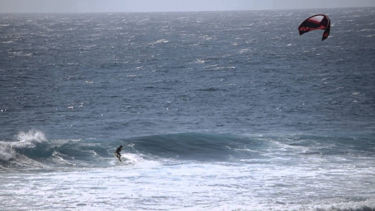 kite surfer at yallingup Mainbreak rides a wave for a bit strapless
