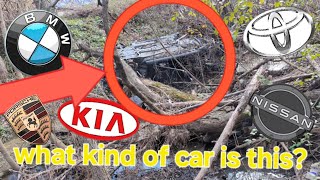 Abandoned vehicle. What is this car? Rolled over car or SUV in the ditch by the train tracks.