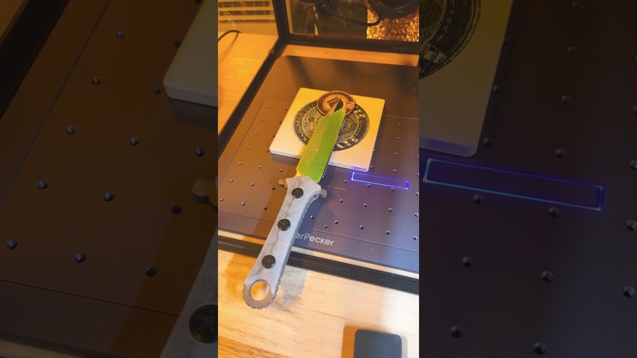 Using some painters tape to do a test engraving on a boot knife 