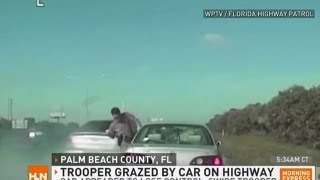 Yikes! Trooper grazed by car on busy highway