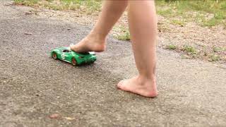 Riding green Ferrari toy model in bare feet