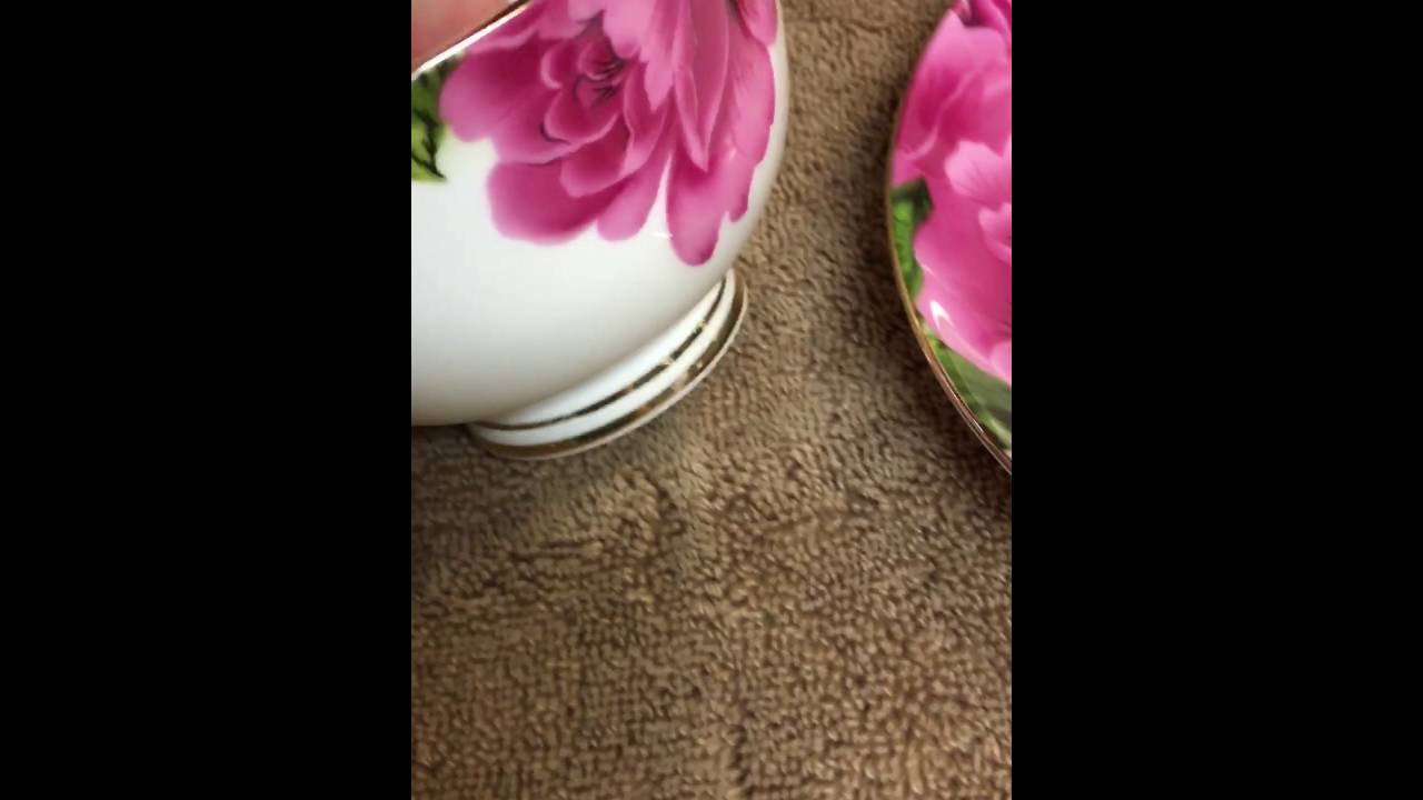 Ceramic coffee cup with saucer and spoon