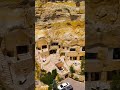 Vertical video. Urgup, Nevsehir, Turkey. Luxury cave hotel rooms carved into rock formations with...