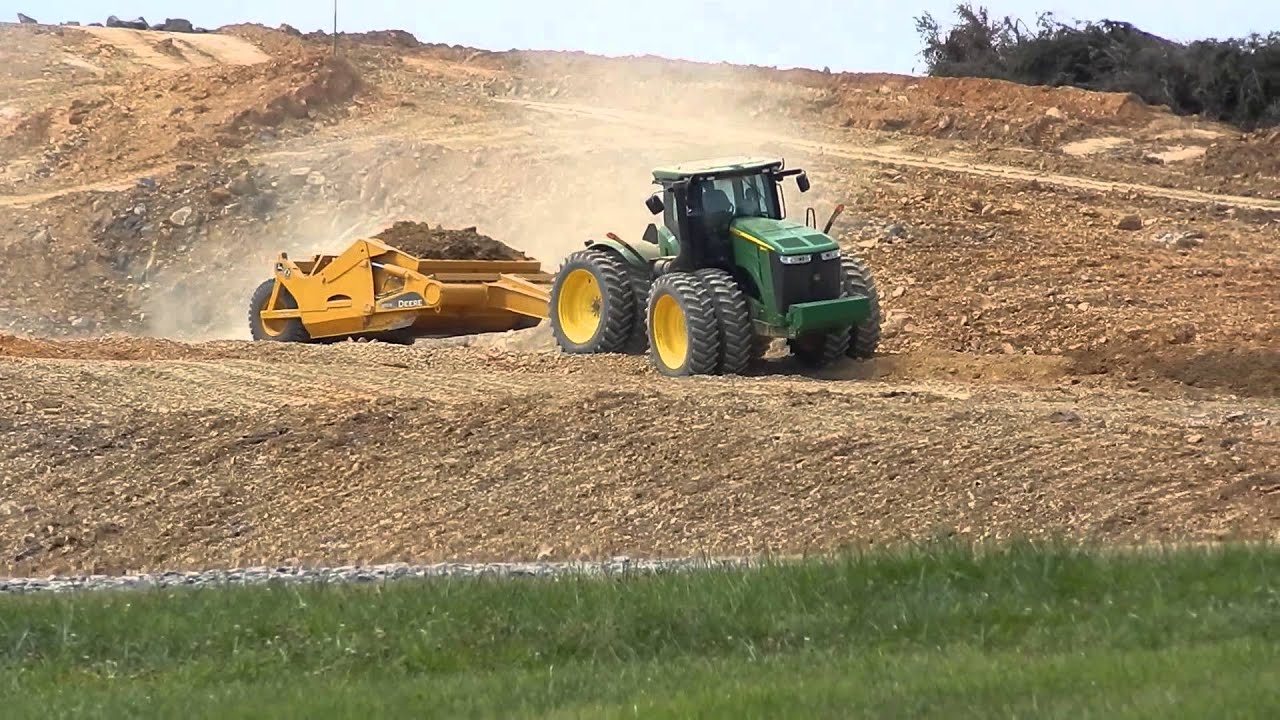 John Deere tractor and pan moving dirt. YouTube