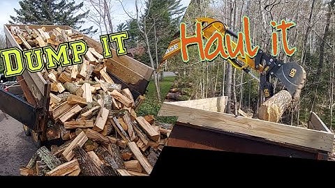 Dump trailer and mini excavator getting firewood done
