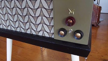 V-M automatic record player playing a stack of 45 records.