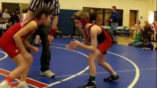 Youth wrestling girl pins boy with outside cradle wrestling technique