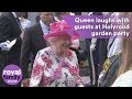 The Queen laughs with guests at Holyrood garden party