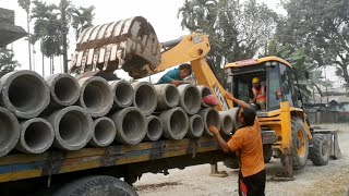 JCB Backhoe Loader Unloading Culvert Pipe From LowBed Truck - JCB And LOWBED TRUCK - EarthPlanet