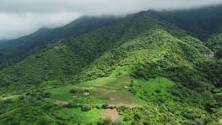 Lush Green Mountains Under Cloudy Skies