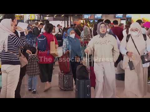Passengers await updates with flights cancelled at Jakarta airport as Anak Krakatau volcano erupts