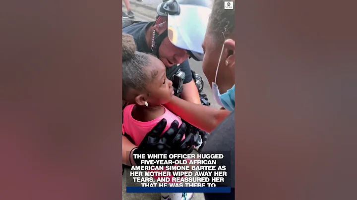 Police officer comforts 5-year-old girl at George Floyd protest