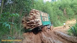 The wooden market cart got stuck on a narrow road because the road was slippery