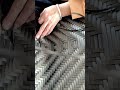 weaving synthetic rattan strips to create a durable and stylish pattern for a piece of furniture