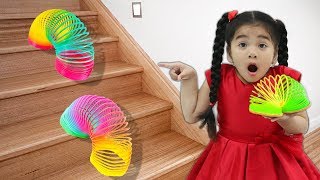 Suri Playing with Colorful Rainbow Slinky Toy