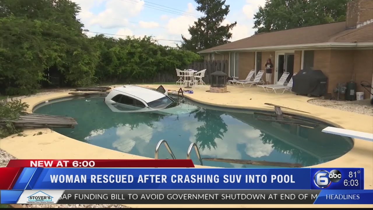 Woman rescued after crashing SUV into pool - YouTube