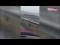 Caravan blown off mountain road and plummets down cliff as unexpected weather hits in this shocking