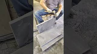 Skilled Artisan Manually Splitting Natural Slate Stone Tiles With Precision Tools