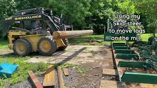 Using a Skidsteer with forks, to move logs around the Mill.