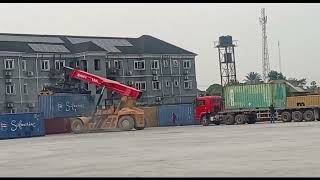 Logistics loading and unloading Containers on a truck at the sea port with Reach Stacker