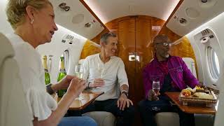 VideoVault Stock Video: Passengers toast with champagne in a private jet
