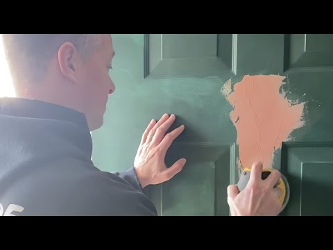Repairing dents in a metal door