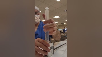 Inspecting DaVinci arms for cleanliness before packaging.