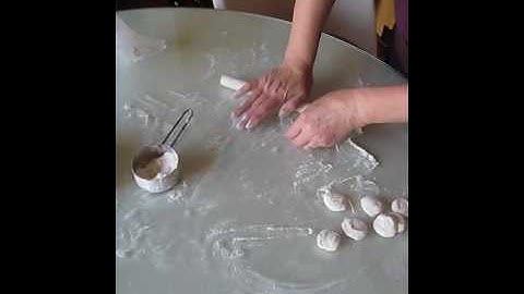 Mama Guan rolling out the dumpling wrappers by hand