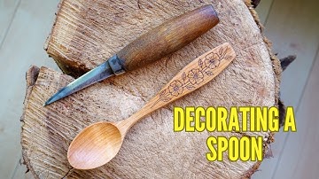 Decorating A Spoon. Traditional Art Of Kolrosing.