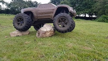 Traxxas X Maxx slow mo over some small rocks