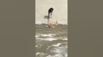 Cast net fishing during reservoir floodwater release