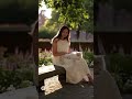 She sits on a stone bench in a quiet garden in Bruges, Belgium - Sora 2 #sora2 #travel