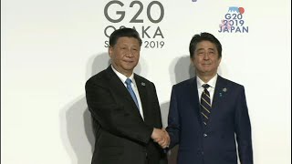 Xi and Abe shake hands at G20 | AFP