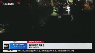 Firefighters in Northridge battle flames consuming home