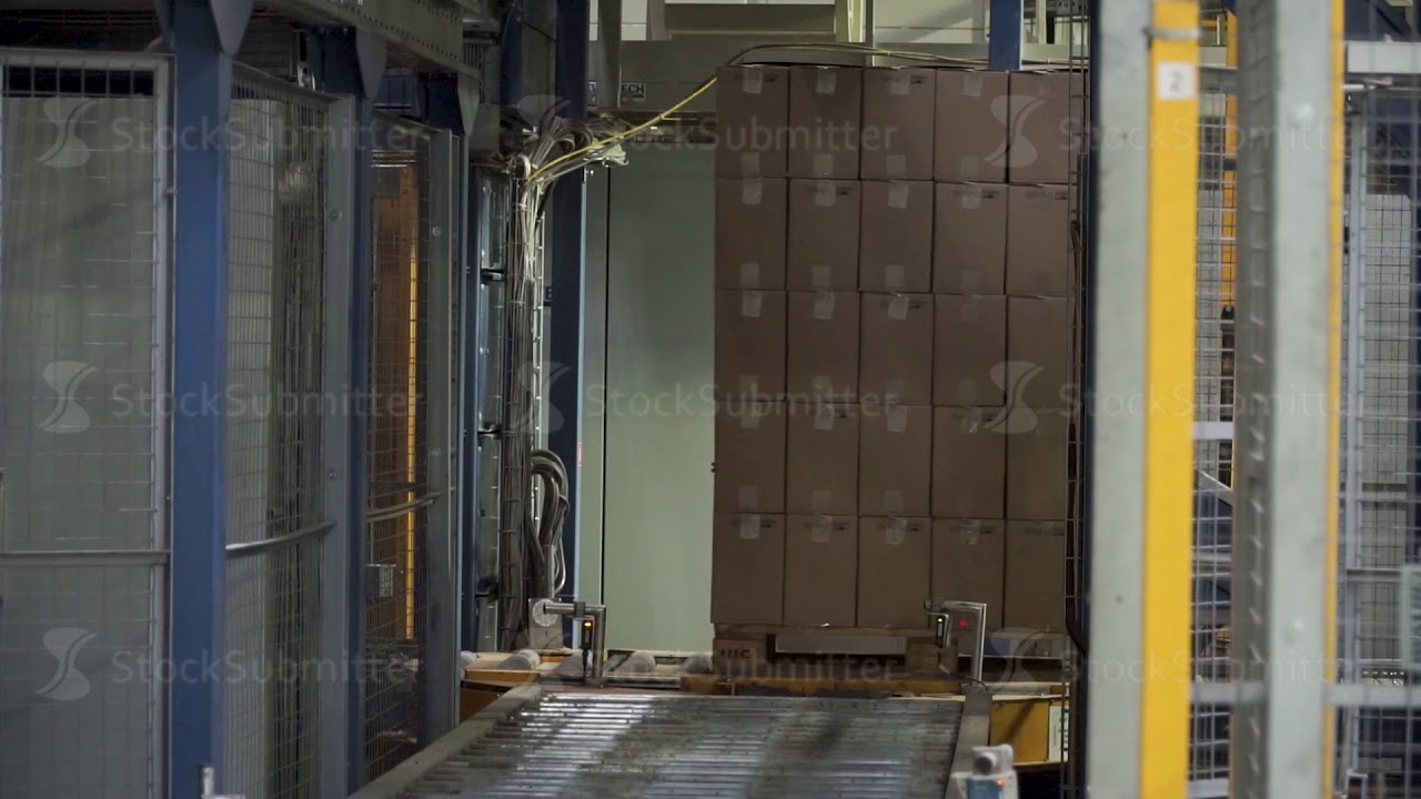 Shipping box in motion on conveyor belt, end of the line. Clip. Moving conveyor belt with cardboard