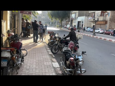 Egyptian motorbikes in streets of Qena. A man polishing his old and beloved car. (excerpt)