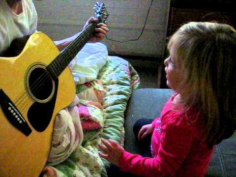 Kate playing guitar.
