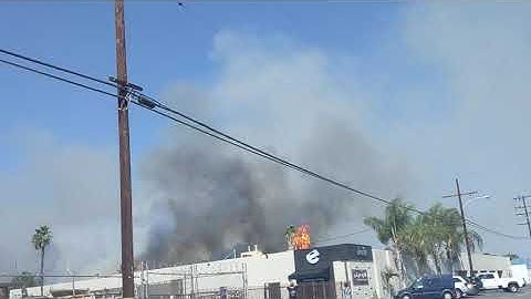 OCFA Copter doing water drop on burning Palm Trees