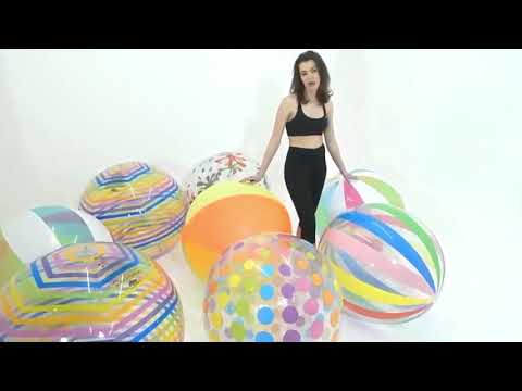 Girl poping and deflating large beach balls