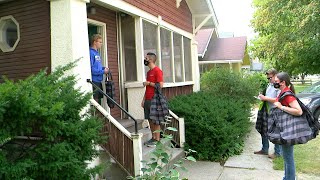 ISU staff talking with student outside off-campus house