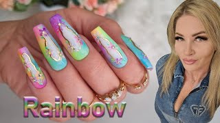 Vibrant Rainbow Nail Art with Delicate Floral Accents. Summer ombre nail art.