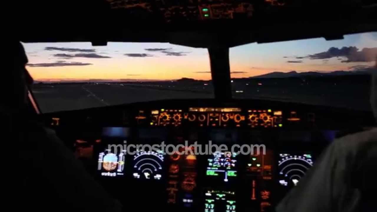 Pink sunset viewed from airplane cockpit with dashboard lights - YouTube
