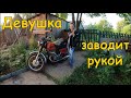 Девушка заводит советский мотоцикл Иж рукой....